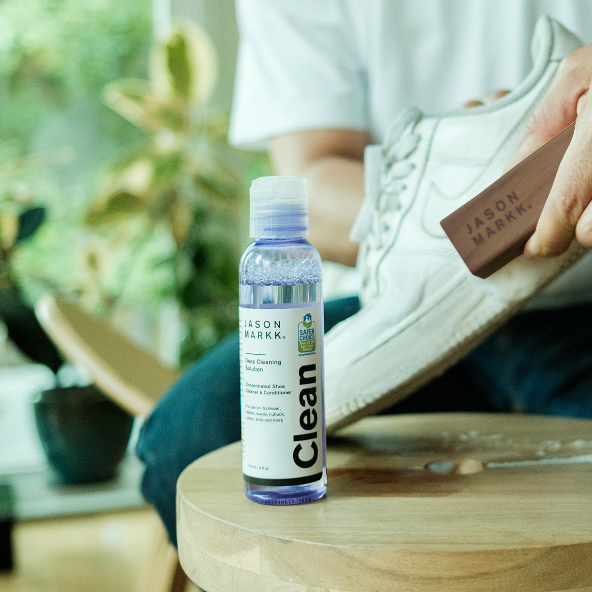 photo if man cleaning shows with Jason Markk Delicates Brush and 8oz Premium Cleaning Solution
