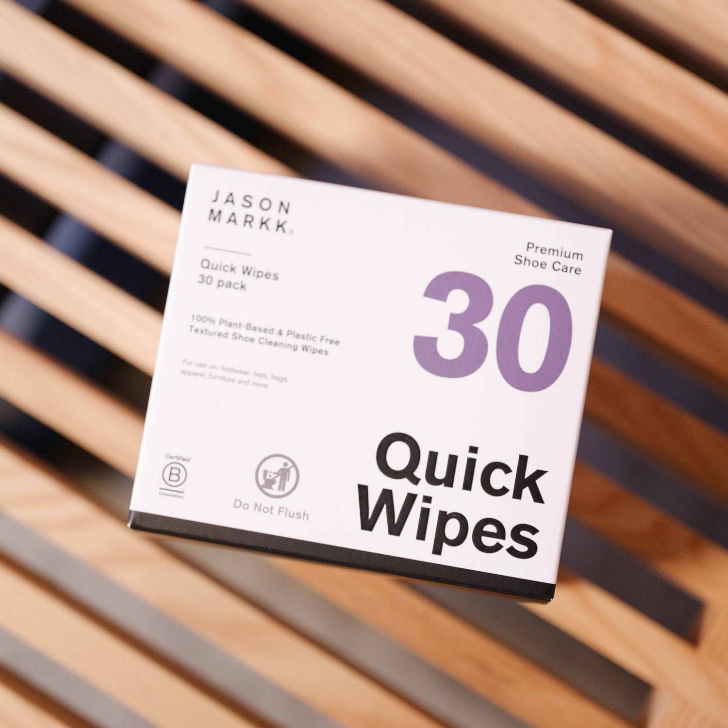 A photo of the Jason Markk Quick Wipe 30 pack box. Showcases the B-Corp certification, that the wipe is 100% plant-based and plastic-free and that you should not flush this product. 