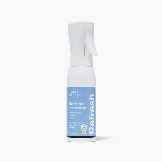 Front view of Jason Markk Refresh Odor Neutralizer spray bottle, 177mL / 6 fl oz. Lightly scented in Sierra Rain. For footwear, hats, and apparel. EPA Safer Choice certified. White continuous mist trigger bottle with a blue label.