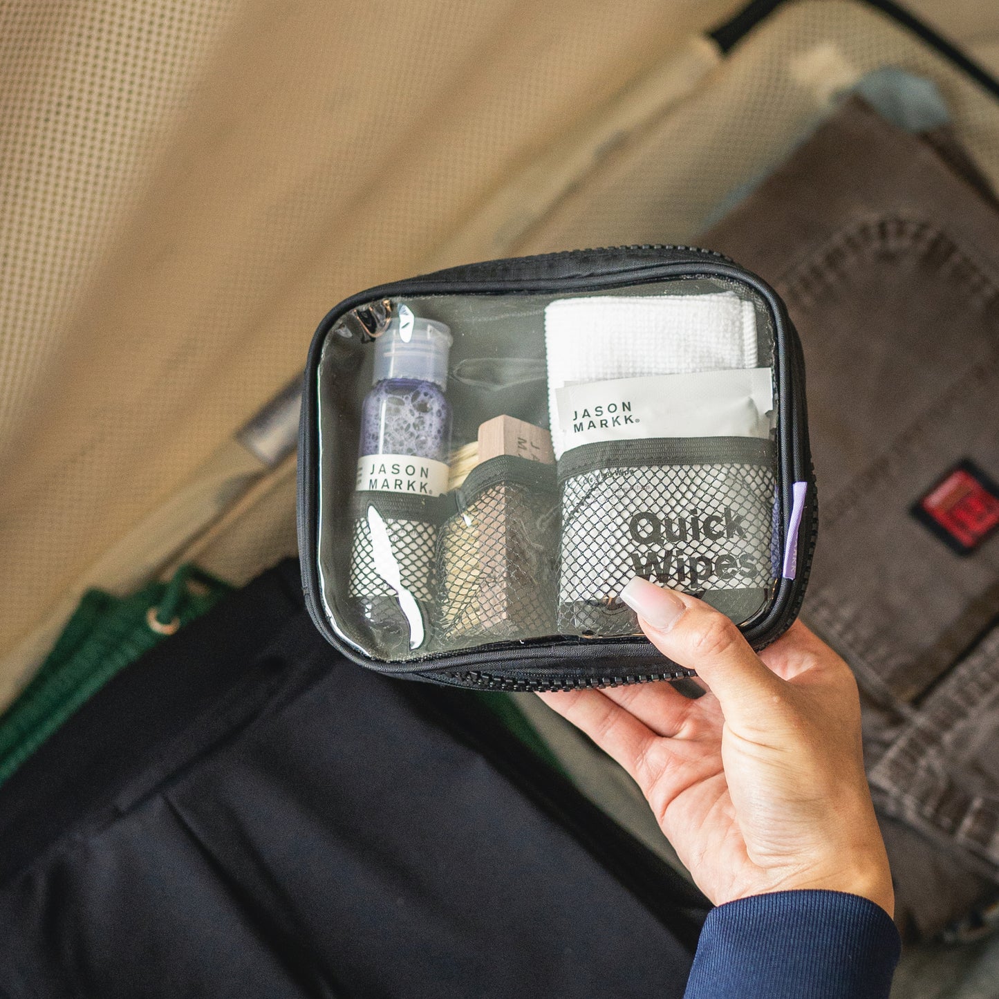 A JASON MARKK TRAVEL KIT IN HAND