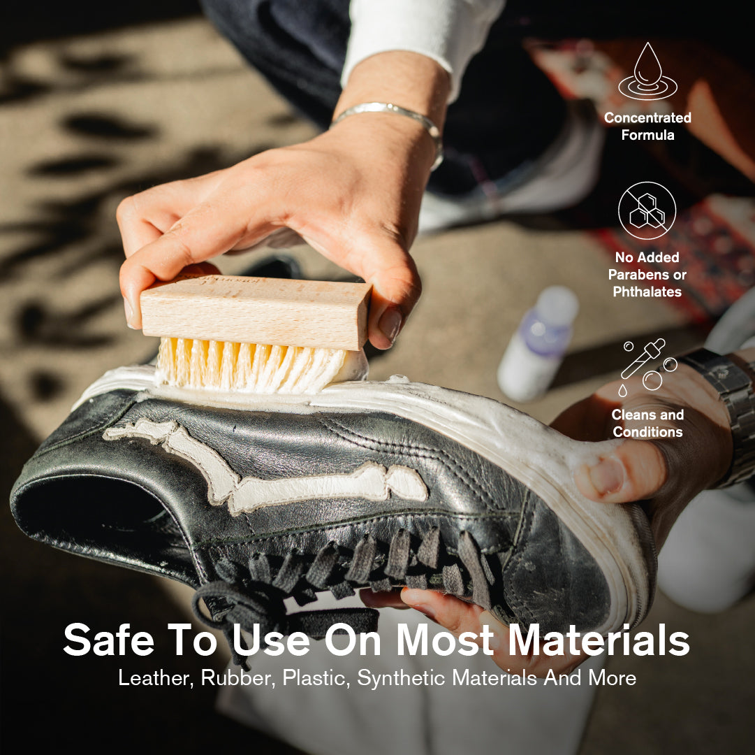 Person cleaning a shoe with a Durables Brush, with text about product safety on various materials.