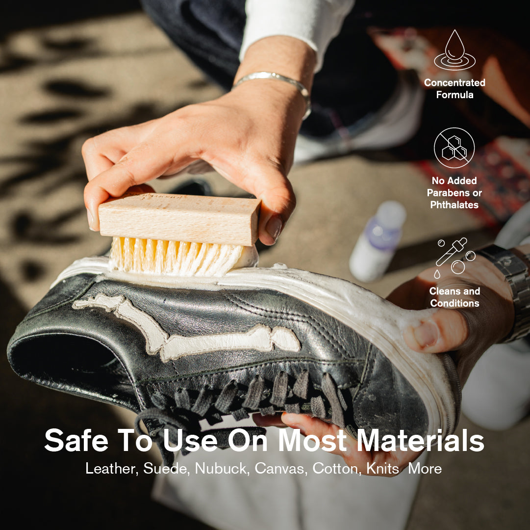 Person cleaning a shoe with a Durables Brush, with text about product safety on various materials.