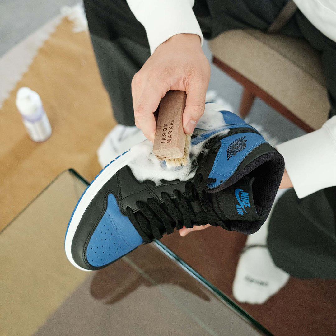 Person cleaning Jordans with the Care Kit