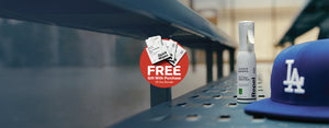 Jason Markk Repel Stain & Water Repellent Spray bottle and Quick Wipes shoe cleaning packets displayed on a stadium bleacher beside an LA Dodgers cap. Red badge reads: FREE Gift With Purchase of Any Bundle. Clean, game-day ready footwear care essentials for cleats, sneakers, hats, and apparel.