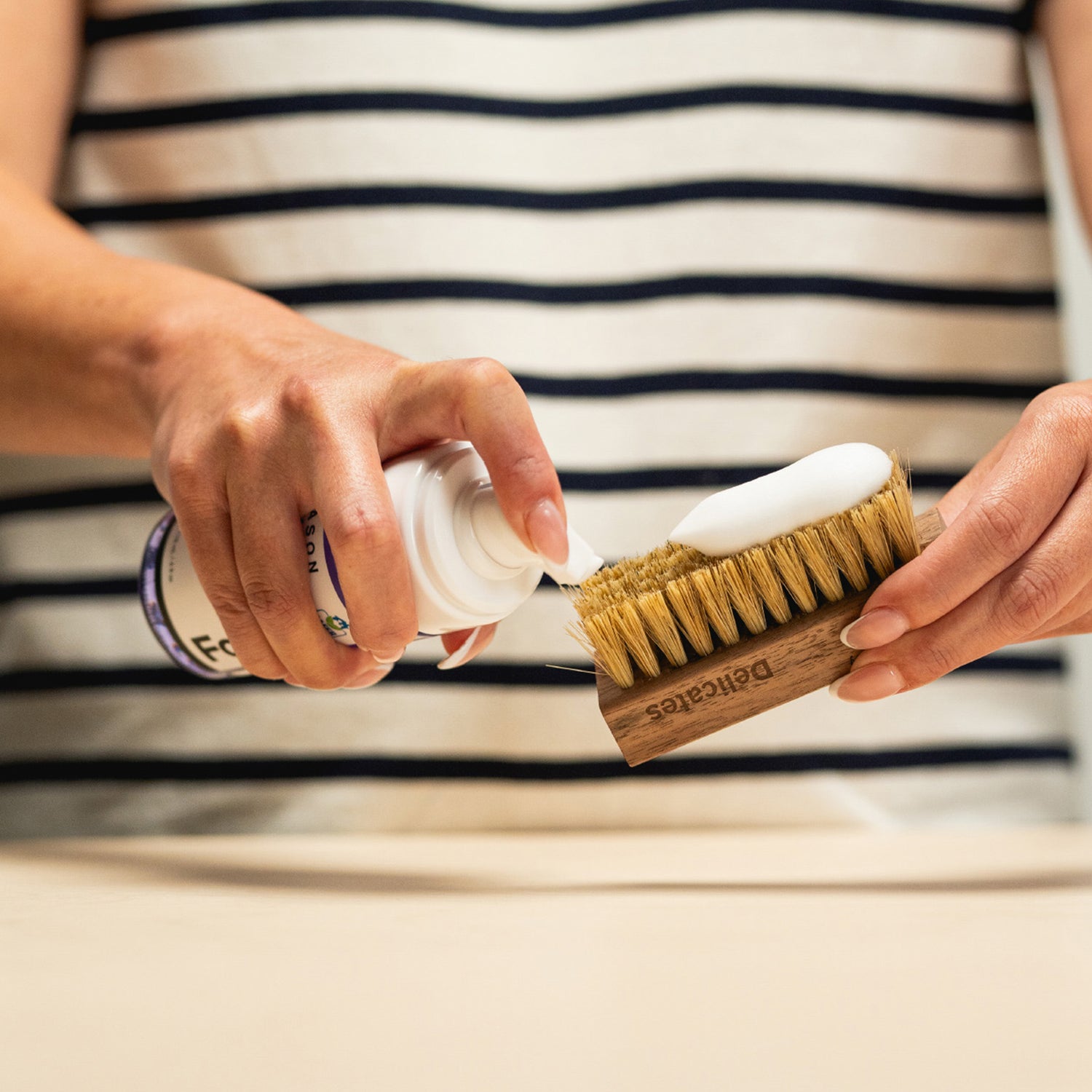 APPLYING JASON MARKK FOAM CLEANER ON TO BRUSH