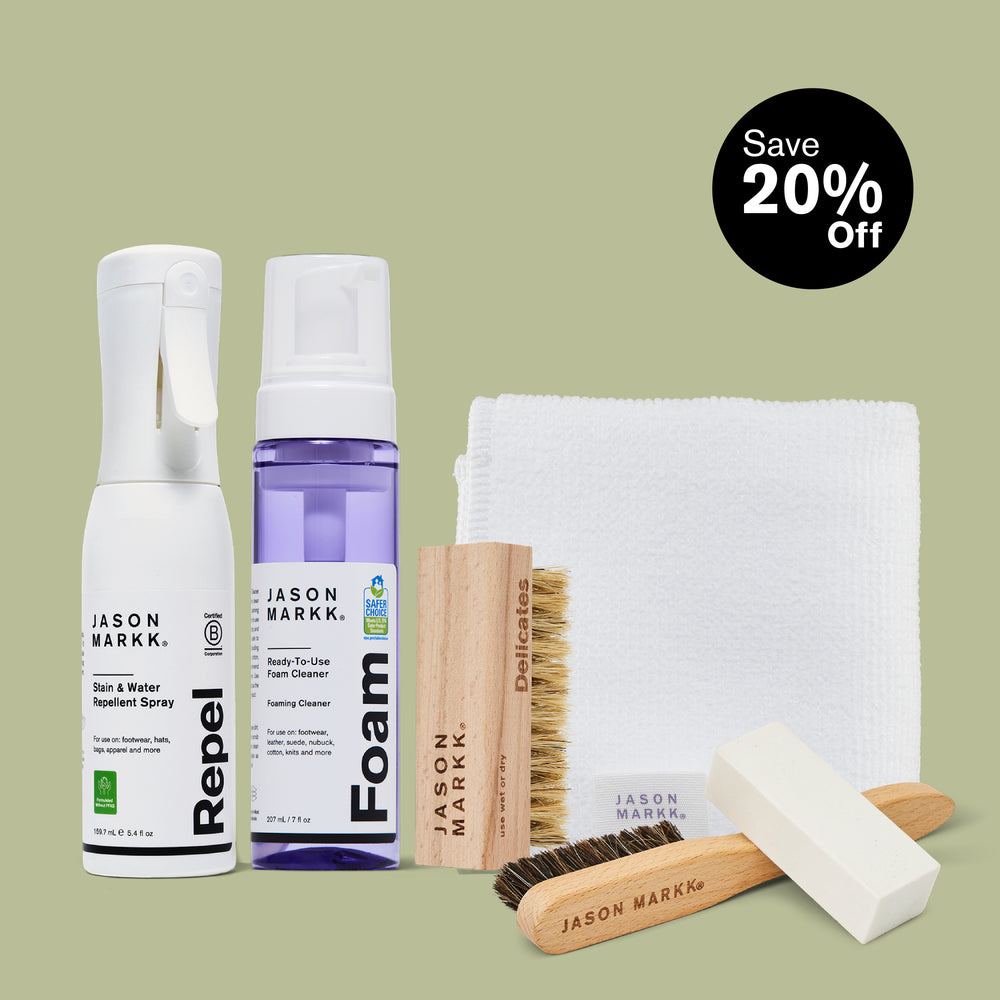 Jason Markk Suede Care Bundle – Save 20% Off. Set includes Repel Stain & Water Repellent Spray (5.4 fl oz, B Corp certified), Ready-To-Use Foam Cleaner (7 fl oz, Safer Choice certified), Delicates brush, Suede brush, Suede eraser block, and white microfiber towel. Displayed on a sage green background.