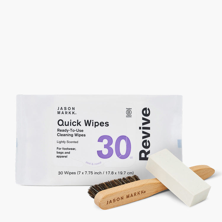 Jason Markk shoe care bundle on a white background. White wipes pack reads "Jason Markk Quick Wipes Revive, Ready-To-Use Cleaning Wipes, Lightly Scented, For footwear, bags and apparel, 30 ct, Peel & reseal, 30 Wipes (7 x 7.75 inch / 17.8 x 19.7 cm)." A wooden cleaning brush branded "Jason Markk" and a white shoe cleaning eraser bar rest in front. Certified B Corporation logo shown.