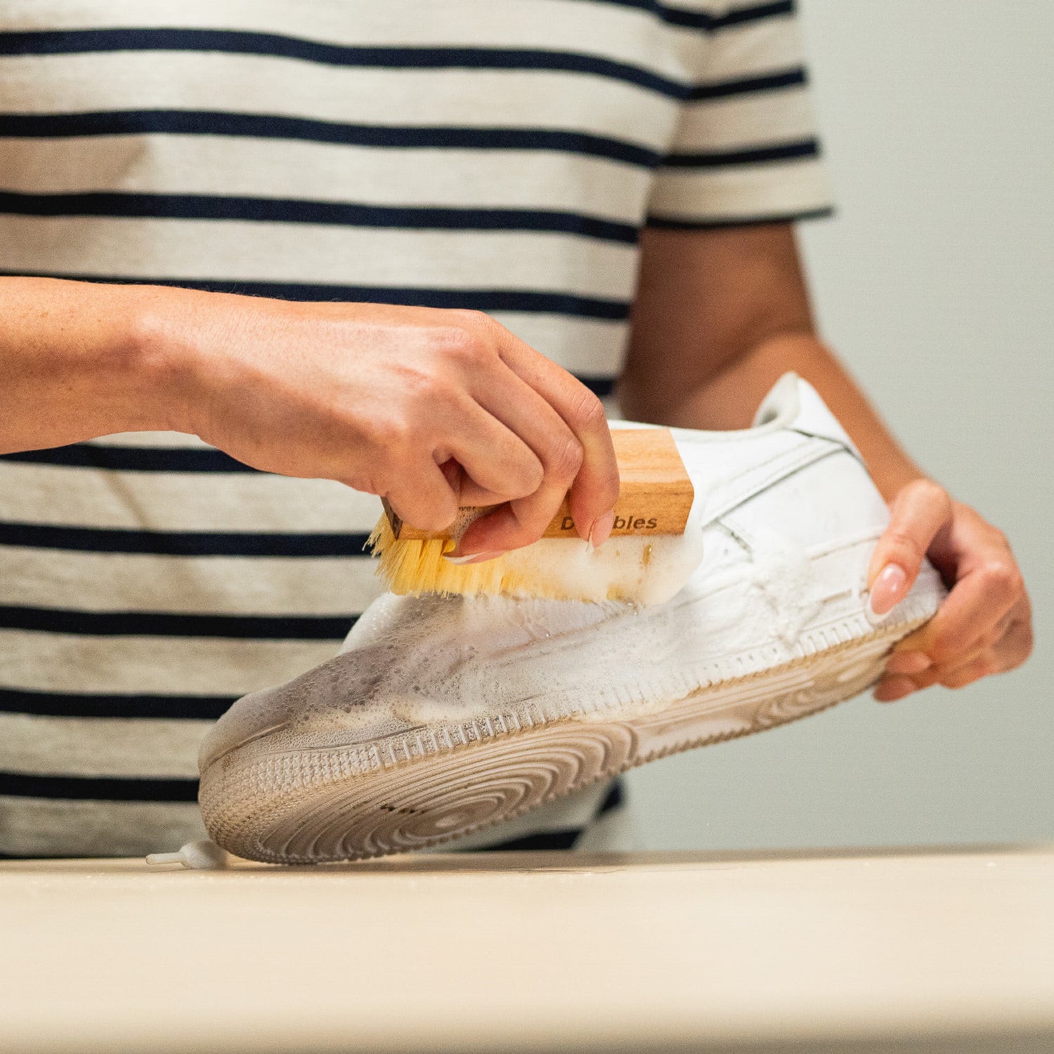 SCRUBBING A NIKE AIR FORCE 1 WITH A JASON MARKK DURABLES CLEANING BRUSH AND FOAM CLEANER