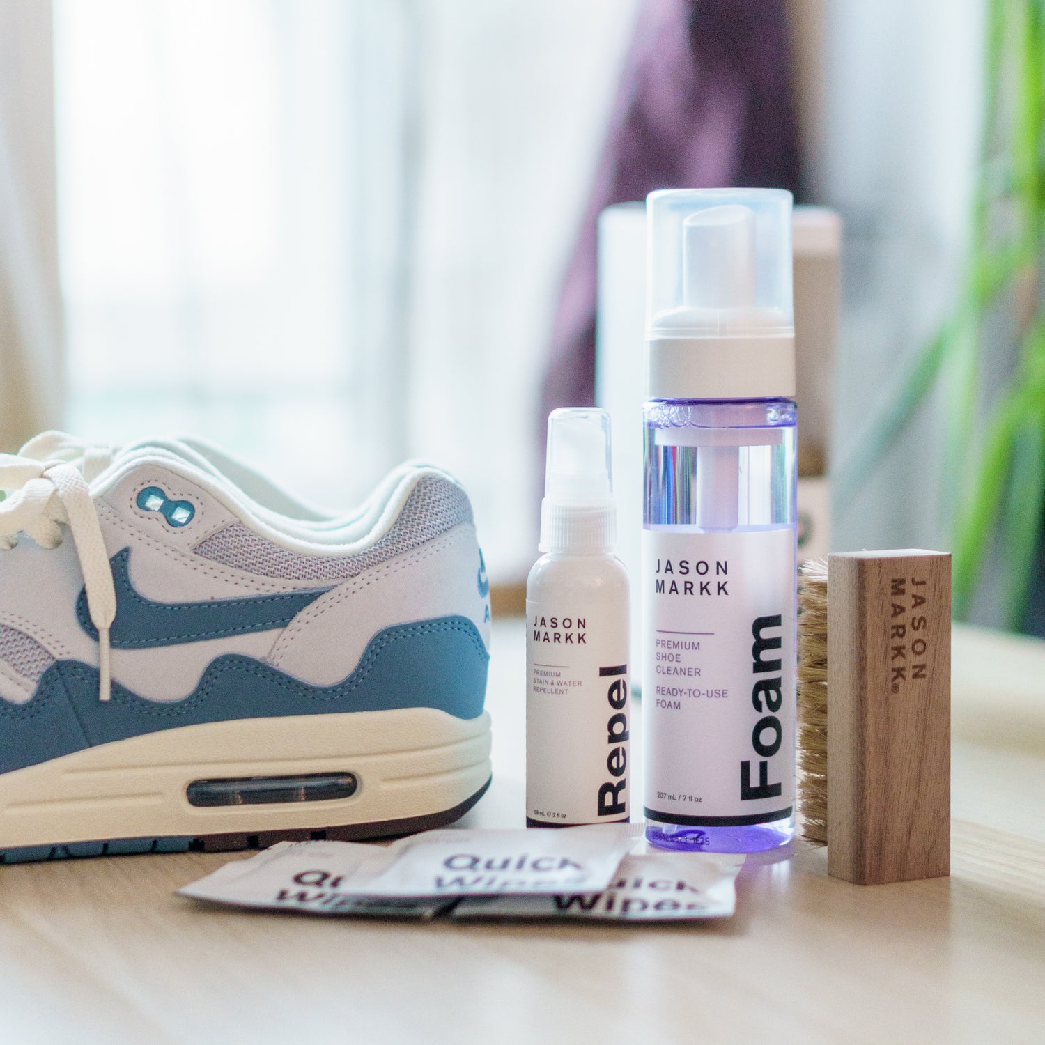 AN UNPACKED JASON MARKK CARE KIT ON A TABLE WITH A PAIR OF NIKE AIR MAX 1 PATTA