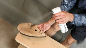 Person spraying Birkenstock Bostons with Repel Spray