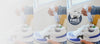 Jason Markk Repel shoe protectant spray being applied to white On-Cloud sneakers in a three-panel sequence. Promotional badge reads: "FREE Gift With Purchase of Any Bundle – Quick Wipes Shoe Cleaning Wipe."