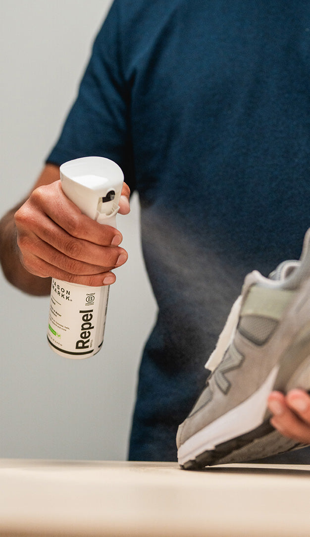 HOLDING A JASON MARKK REPEL SPRAY 6 TO 8 INCHES FROM A VISVIM DENIM JACKET 