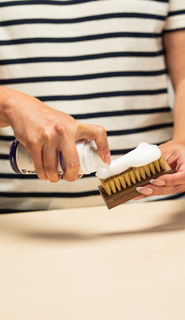 APPLYING JASON MARKK FOAM CLEANER ON TO A JASON MARKK DELICATES CLEANING BRUSH 