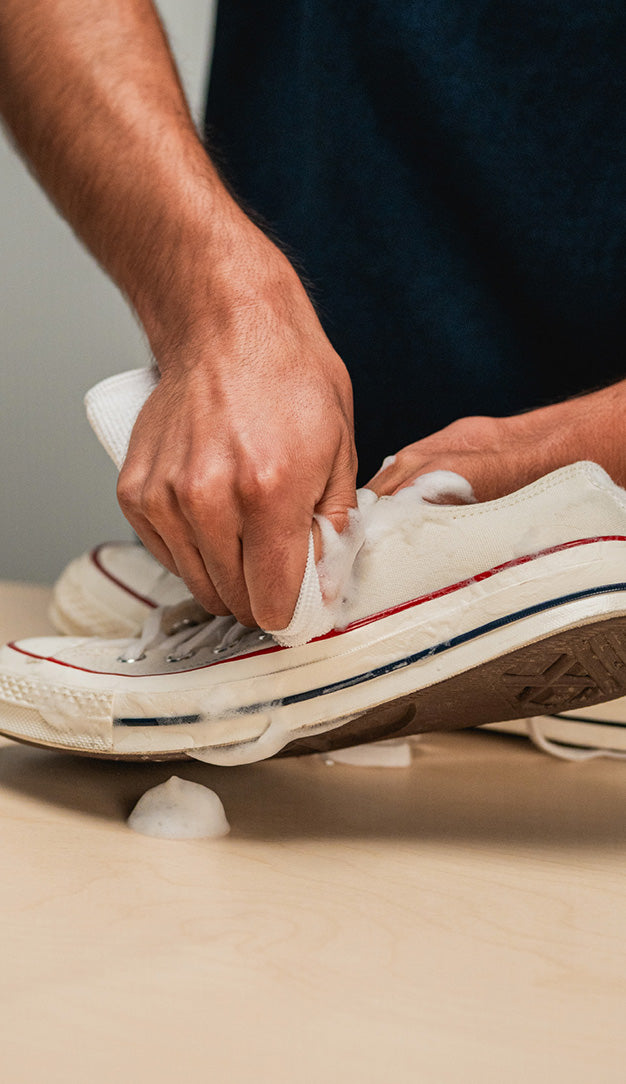 JASON MARKK MICROFIBER TOWEL WIPING A PAIR OF CONVERSE CHUCK TAYLOR LOW 1970 