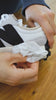 Video of a person using Quick Wipes to clean white sneakers and then a clip of someone spraying a white sneaker with Repel Spray
